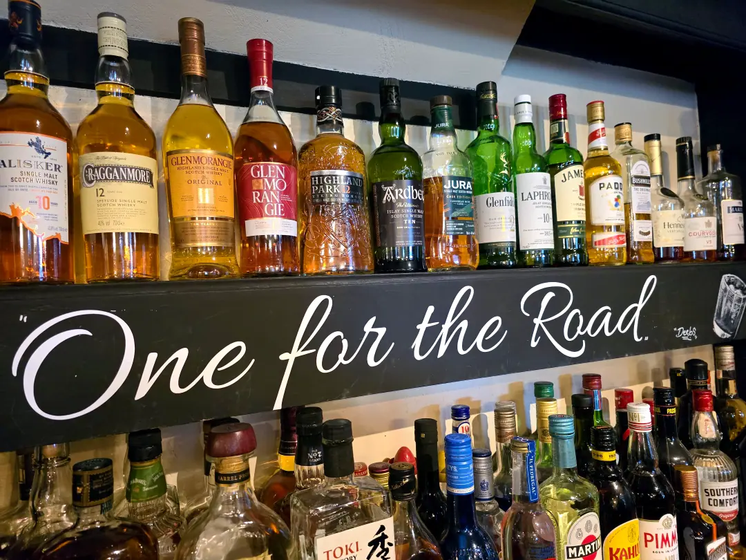 A shelf of single malt whiskies with One for the Road written above